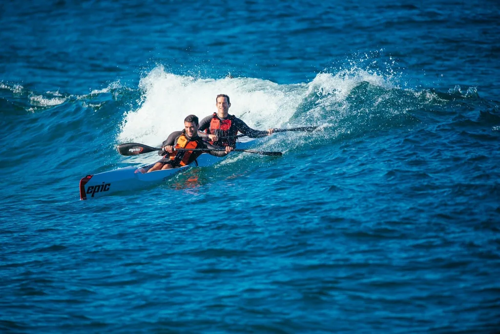 Two paddlers on an Epic double ski in the surf