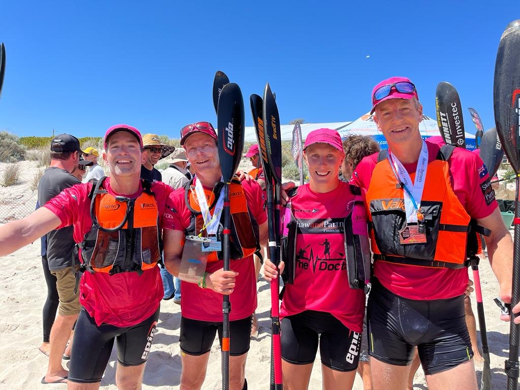 Paddlers with their medals and Epic paddles after a race